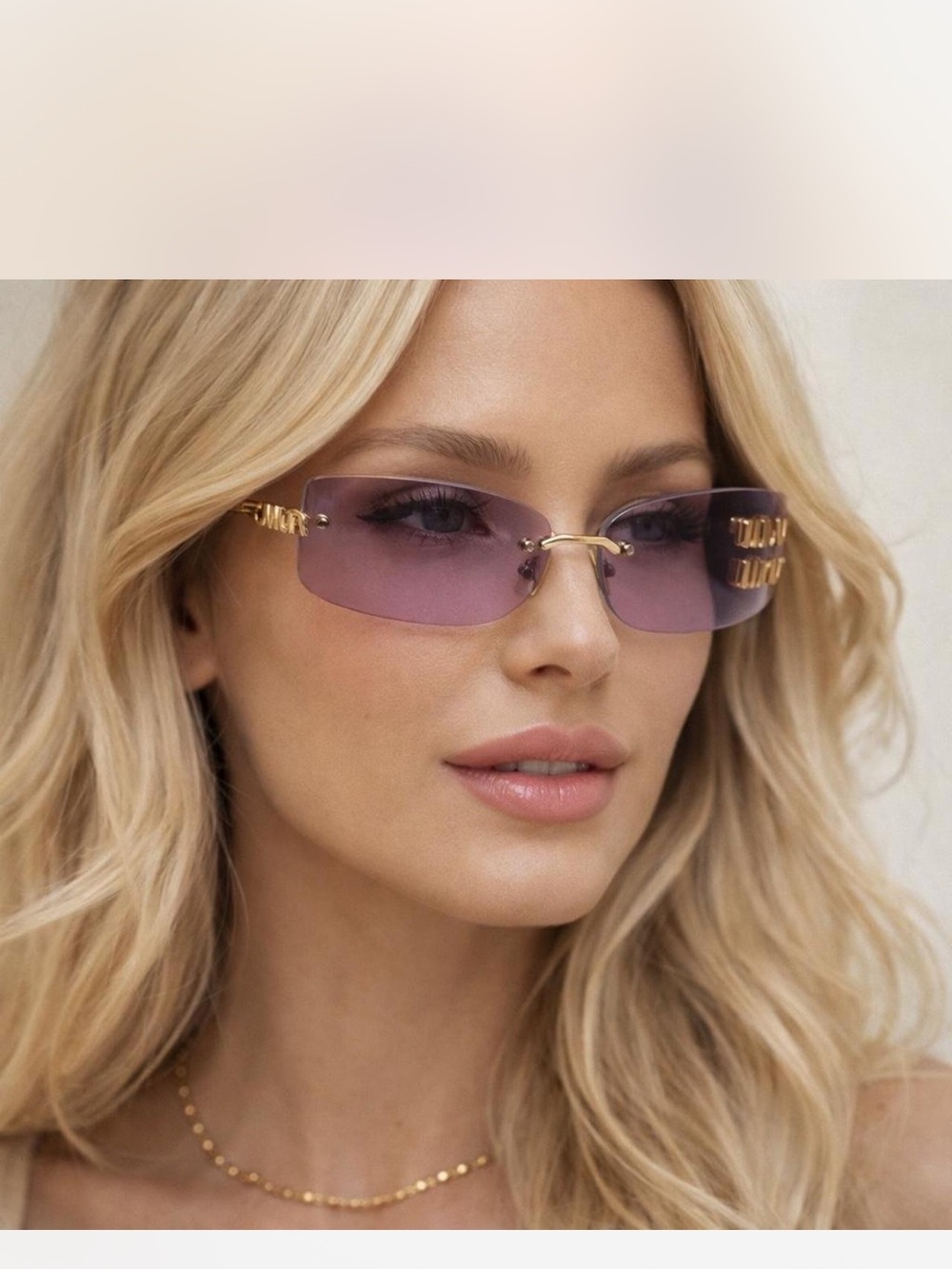 Miu Miu MU A51S sunglasses in a pale gold metal with frameless pink lenses
